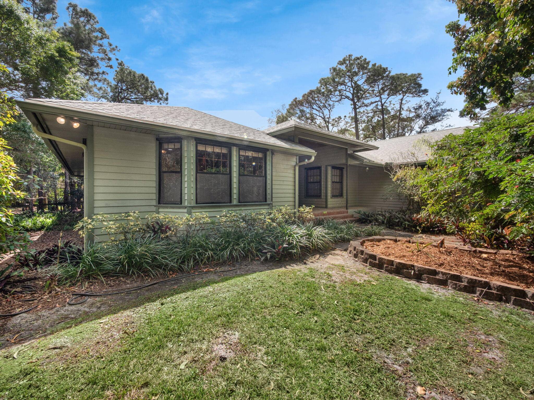 Don't miss viewing this charming Jupiter Farms Estate with Guest Cottage Expansive Outdoor Living Area.