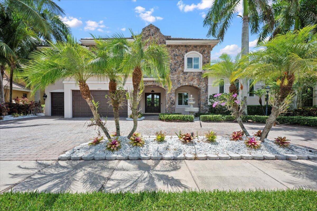 From the moment you step inside this stunning residence in the coveted Versailles neighborhood, you'll be captivated by its soaring vaulted ceilings, abundant natural light, and timeless elegance.
