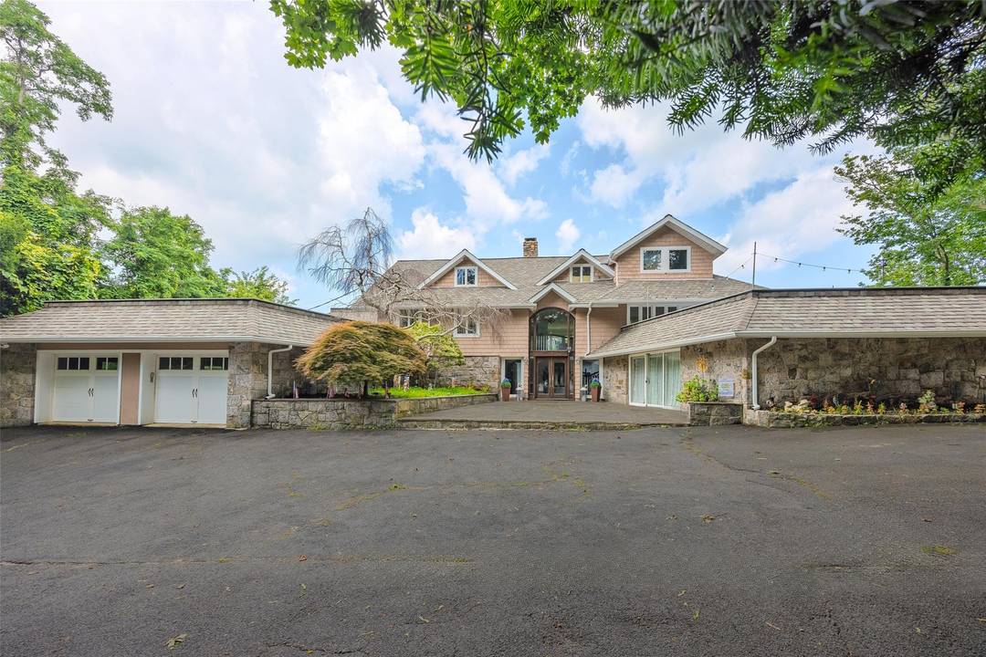 Stunning waterfront manor on almost 3 acres overlooking the Long Island Sound With private beach steps to your own Beach !