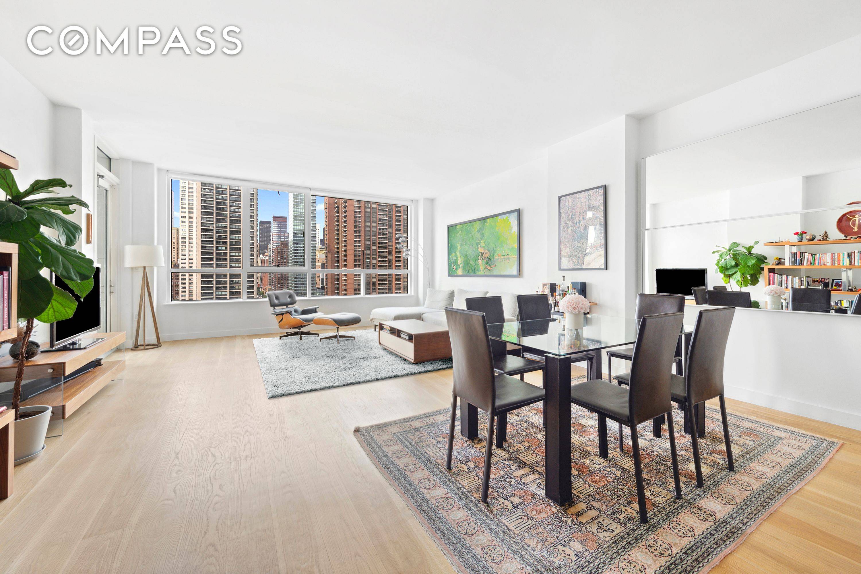 Step into this bright and airy residence, where floor to ceiling windows and a private terrace showcase sweeping open city views, bathing every room in golden southern light.