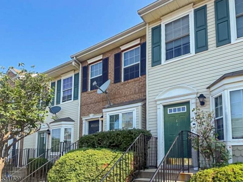 Welcome to 60 Faith Ct, a beautifully maintained interior townhouse in a secure gated community in Newark.
