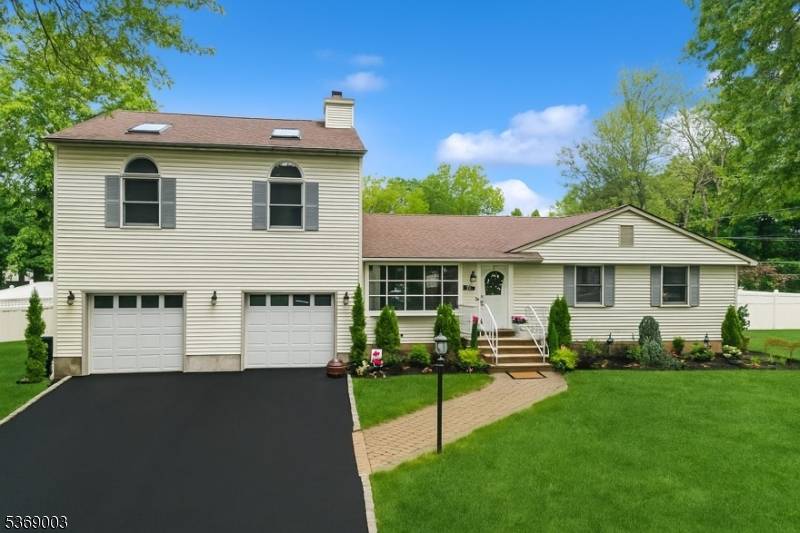 This beautifully expanded four bedroom ranch style residence offers an inviting open floor plan that is perfect for modern living and entertaining, creating an ideal space for gatherings.