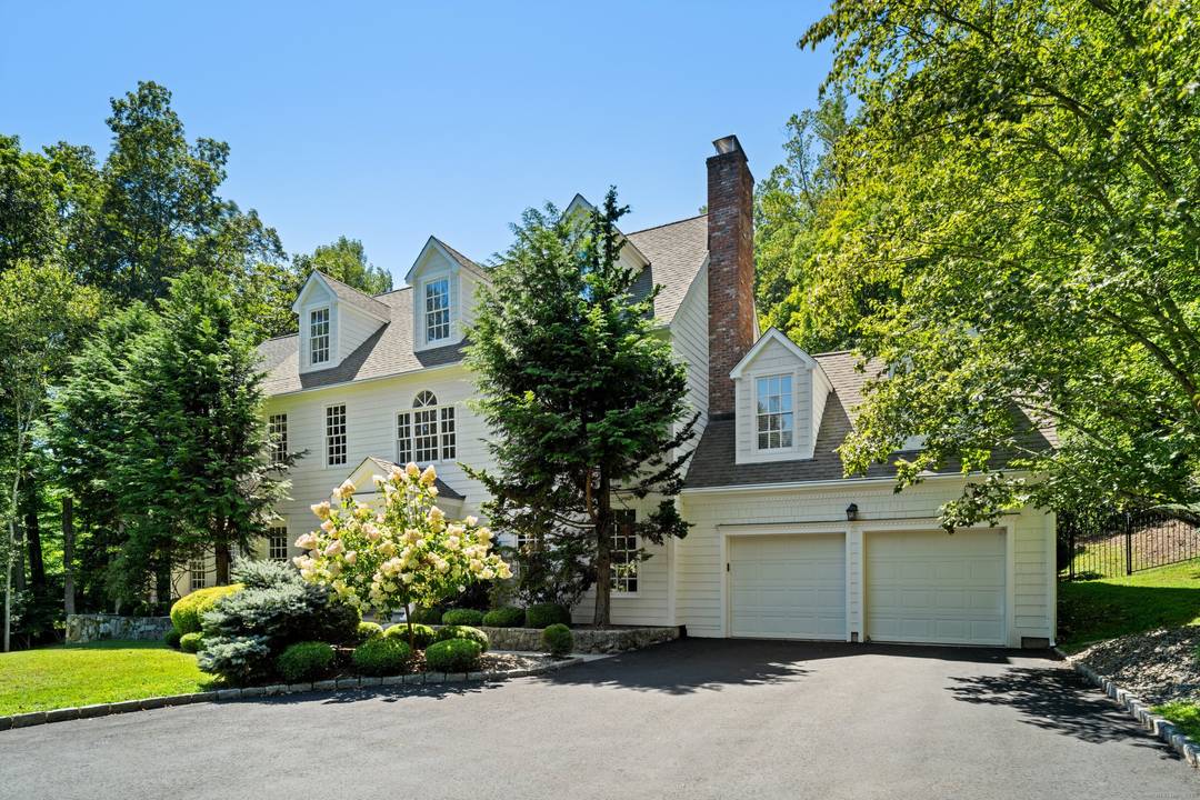 Welcome to 38 Davis Hill Road, Weston a beautifully appointed Colonial residence set on just over 2 private acres with meticulously landscaped gardens, mature plantings, and multiple patios.