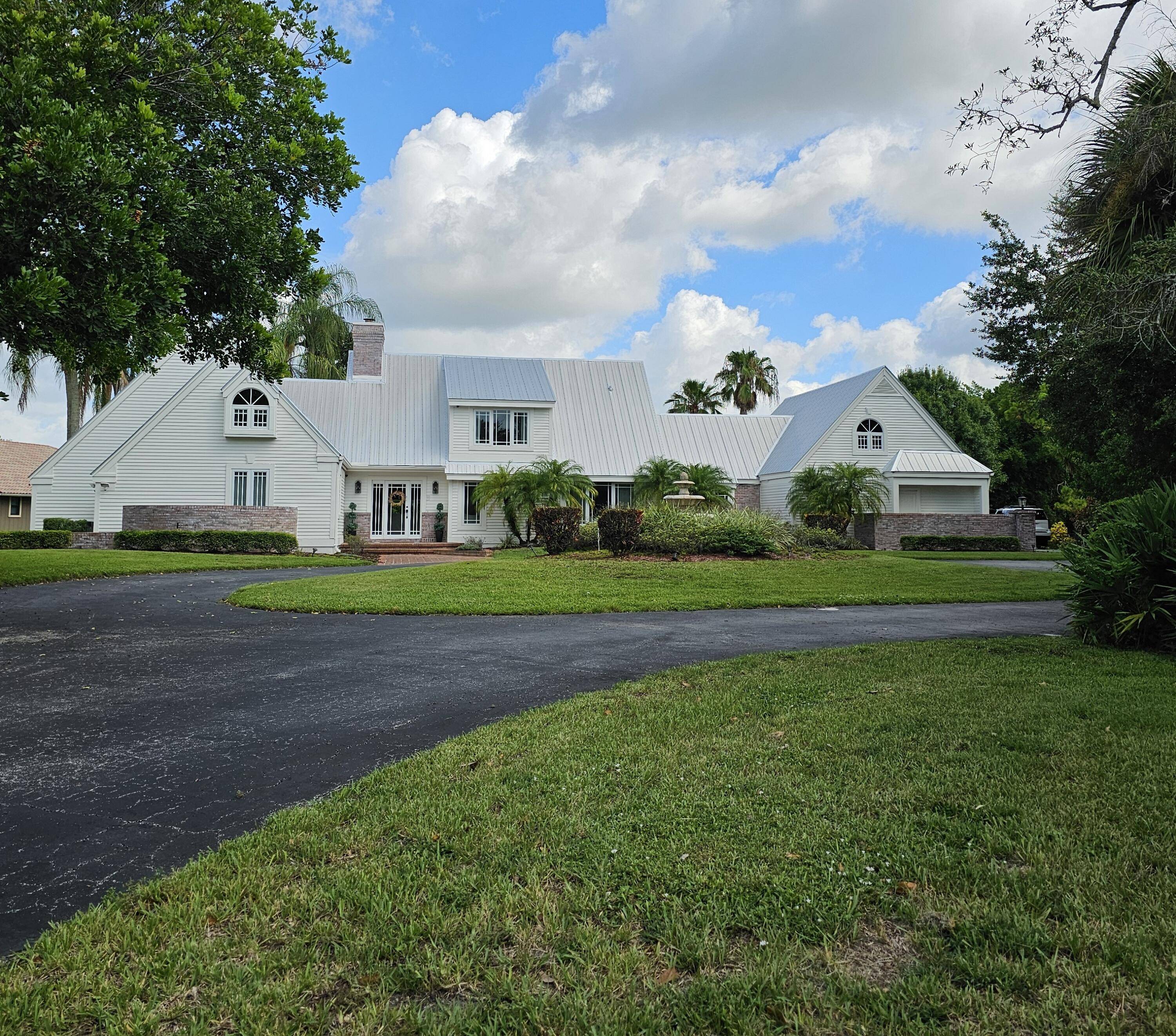 Welcome to one of Palm City's most charming Estate homes located on the golf course on over an acre in the securely gated community of Martin Downs Country Club.