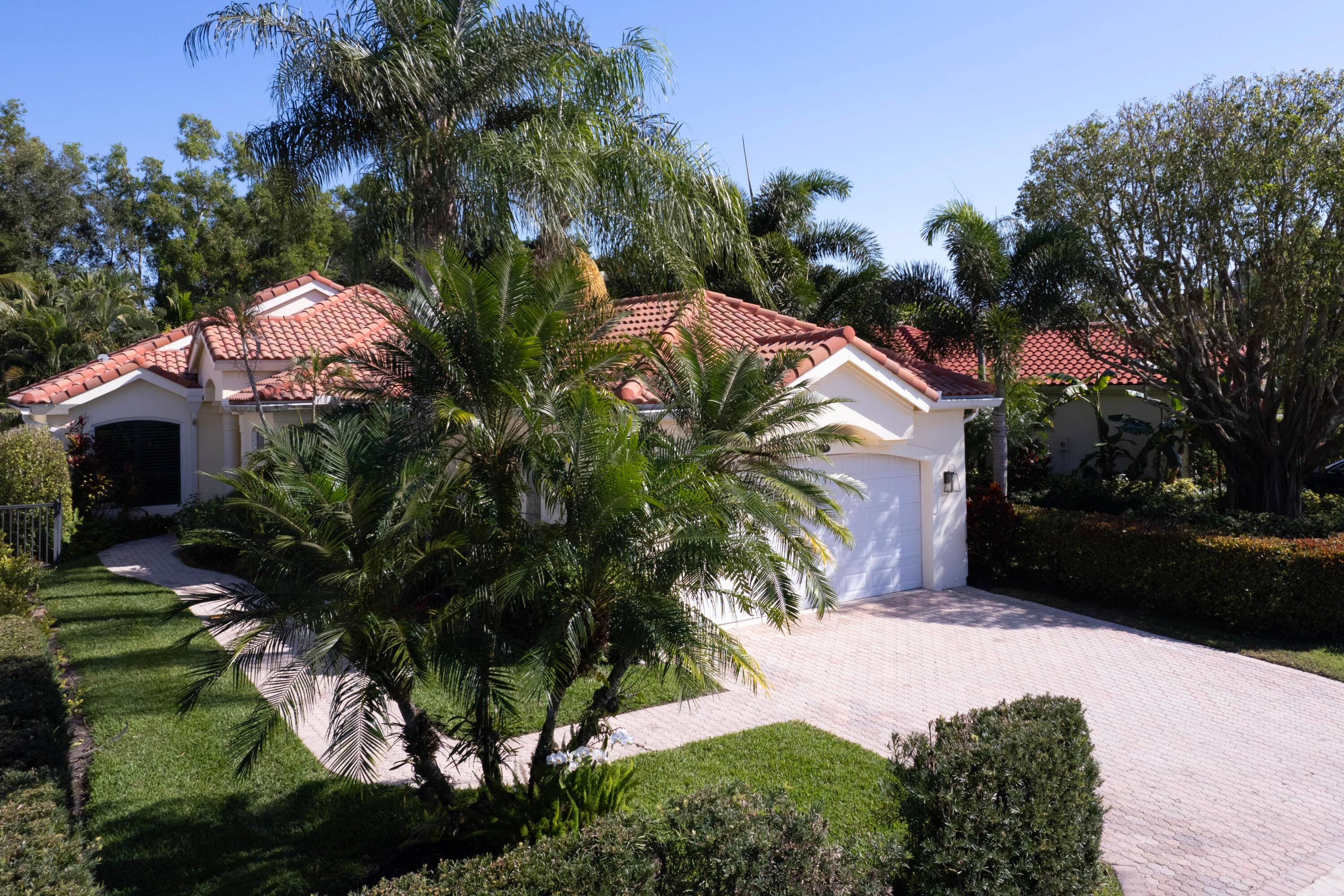 This beautifully renovated single family home in Chukker Cove, Palm Beach Polo Country Club, offers a tranquil retreat with its screened pool, patio, and peaceful gardens.