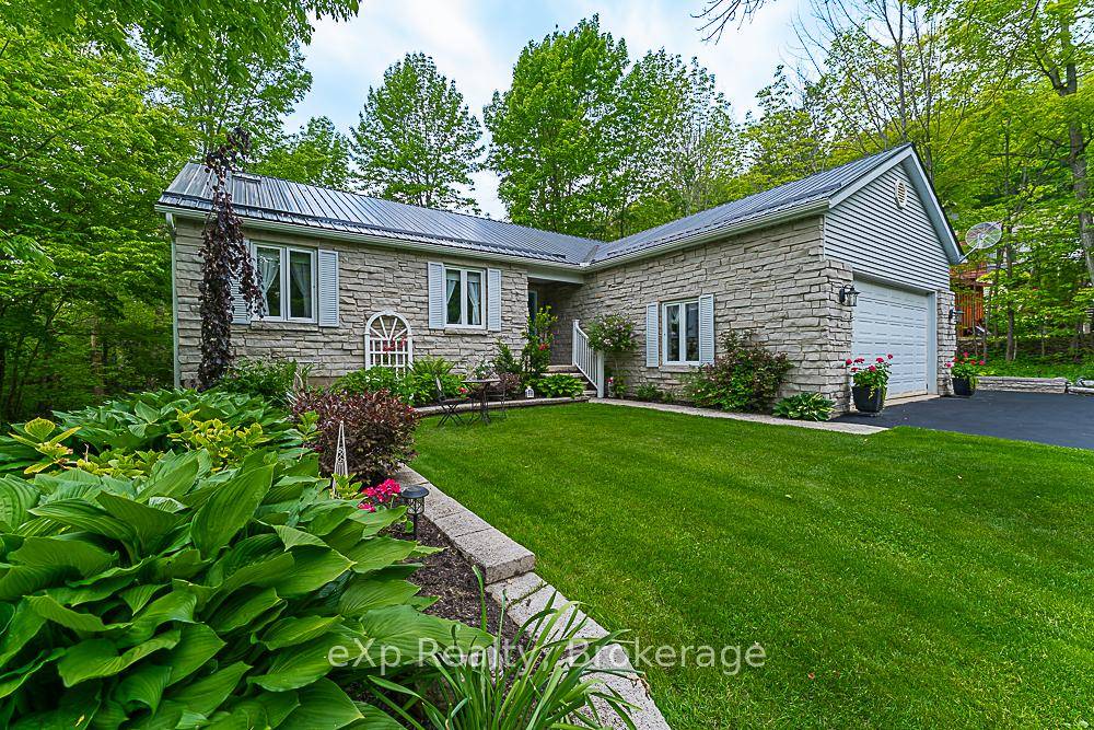 Discover an exceptional residence nestled in a serene location, offering a tranquil retreat with convenient access to Georgian Bay through a newly constructed staircase adjacent to Mallory Beach Road.