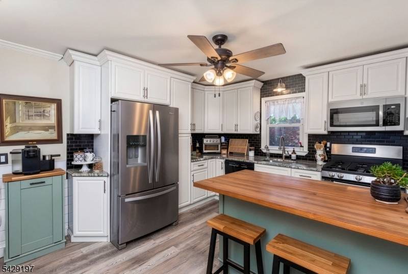 Charming Cape Cod set on a peaceful corner lot, highlighted by a beautiful blooming dogwood tree that welcomes you home.