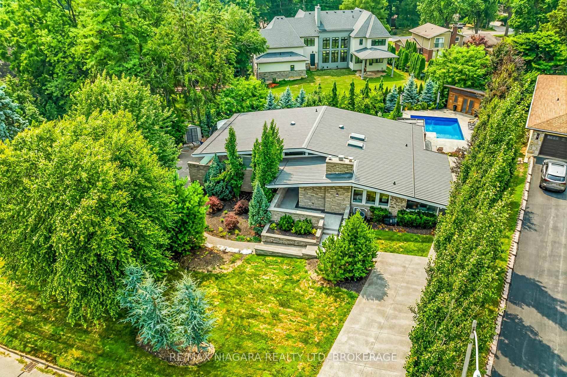 Estate style lot surrounded by mature trees in the gorgeous Bevan Heights location featuring 3 bedrooms with a potential 4th, 5 bathrooms, a Boldt saltwater heated pool, outdoor poolhouse with ...
