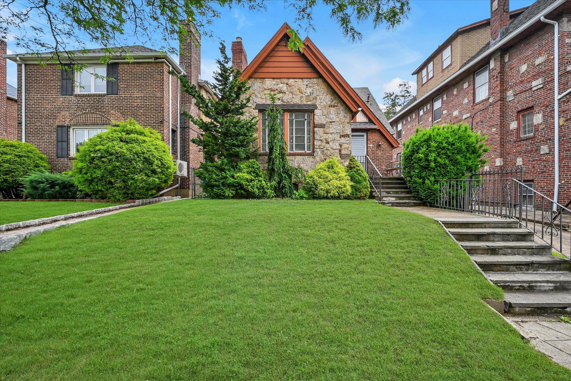 Flushing Well maintiained Detached Brick Tudor, Entry foyer, Living room with vaulted beamed ceiling and wood burning Stone fireplace, Formal Dining room, Updated Kitchen with breakfast nook, 2 bedrooms, updated ...