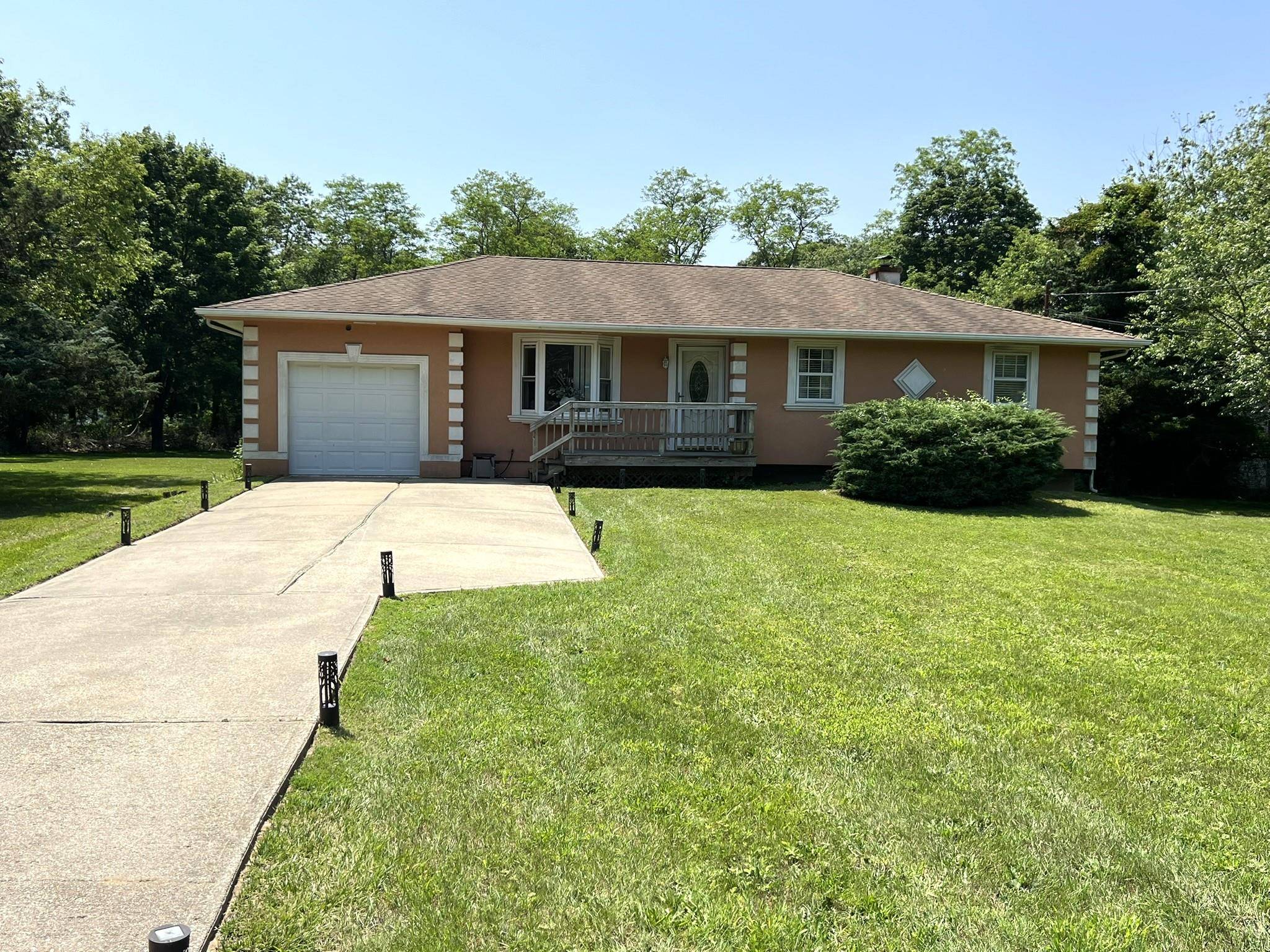 Nestled in the heart of Bellport, this delightful Ranch home boasts a sprawling yard just shy of a half acre perfect for outdoor entertaining, gardening, play, and relaxation.