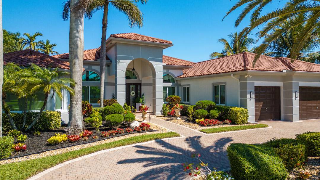 Private estate on nearly 2 acres in prime Davie location with tranquil lake views that offers a rare combination of space and privacy.