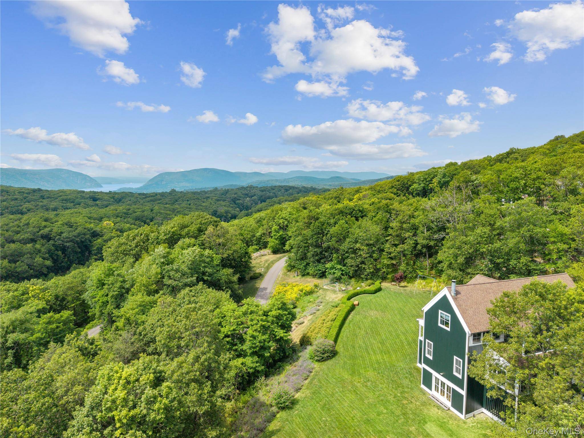 Wooded retreat meets modern comfort in this breathtaking Garrison home, perched atop a gently rolling hill on 5.