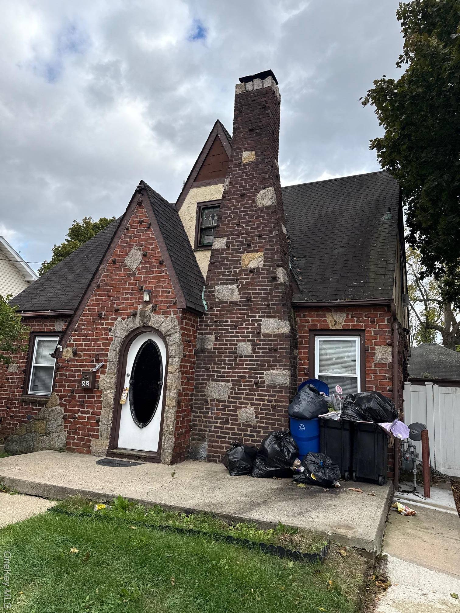 4 Bedroom 3 Bath Tudor Full basement w bath and separate entry Huge detached 2 car garage Needs TLC