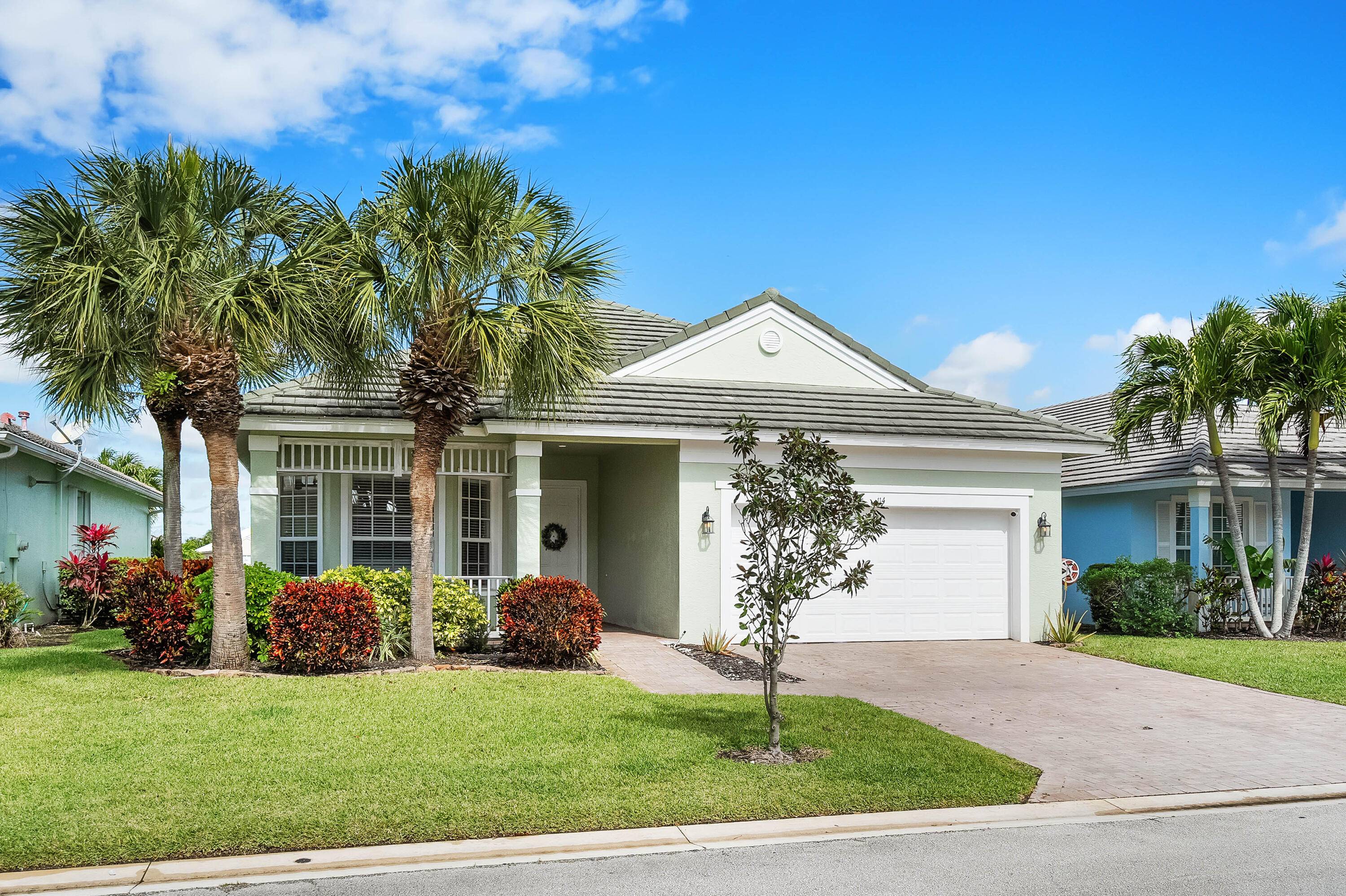 Follow tree lined streets to this striking 4 bedroom, 3 bathroom premium lake view retreat in the sought after, gated community of Magnolia Lakes !