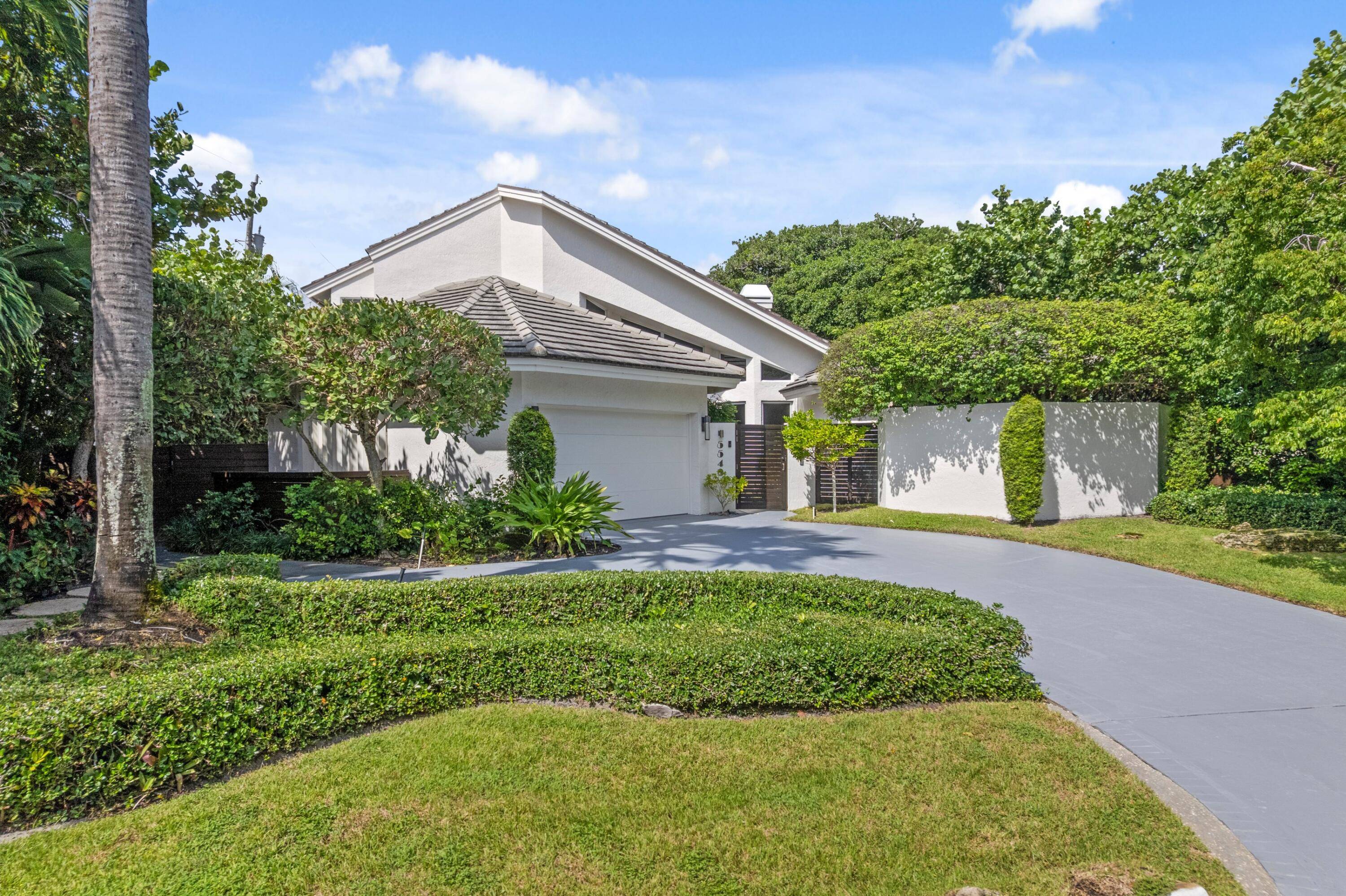 Exuding coastal sophistication, this lushly landscaped four bedroom estate in prestigious Ocean Ridge combines modern elegance with timeless design.