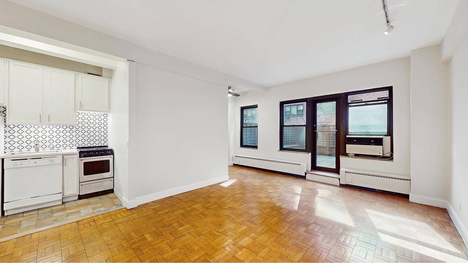 This spacious alcove studio is located in a wonderful Tudor City cooperative building.