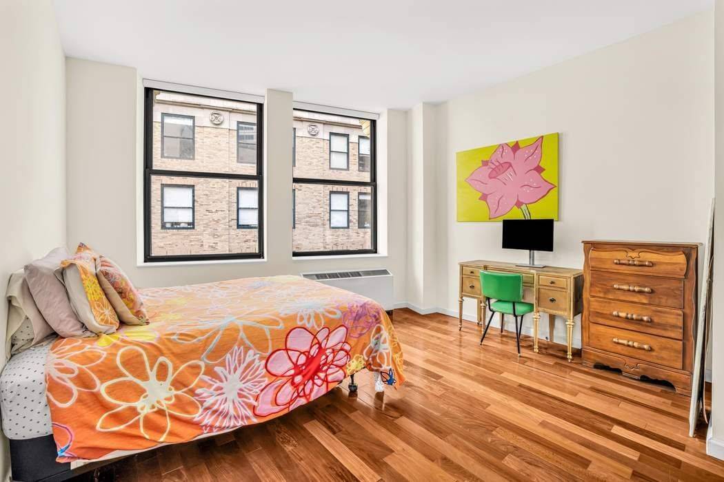 Apartment PH08, Penthouse studio features the modern galley kitchen has stainless steel appliances, granite countertops, outfitted with walnut and glass cabinetry, and includes a storage pantry.