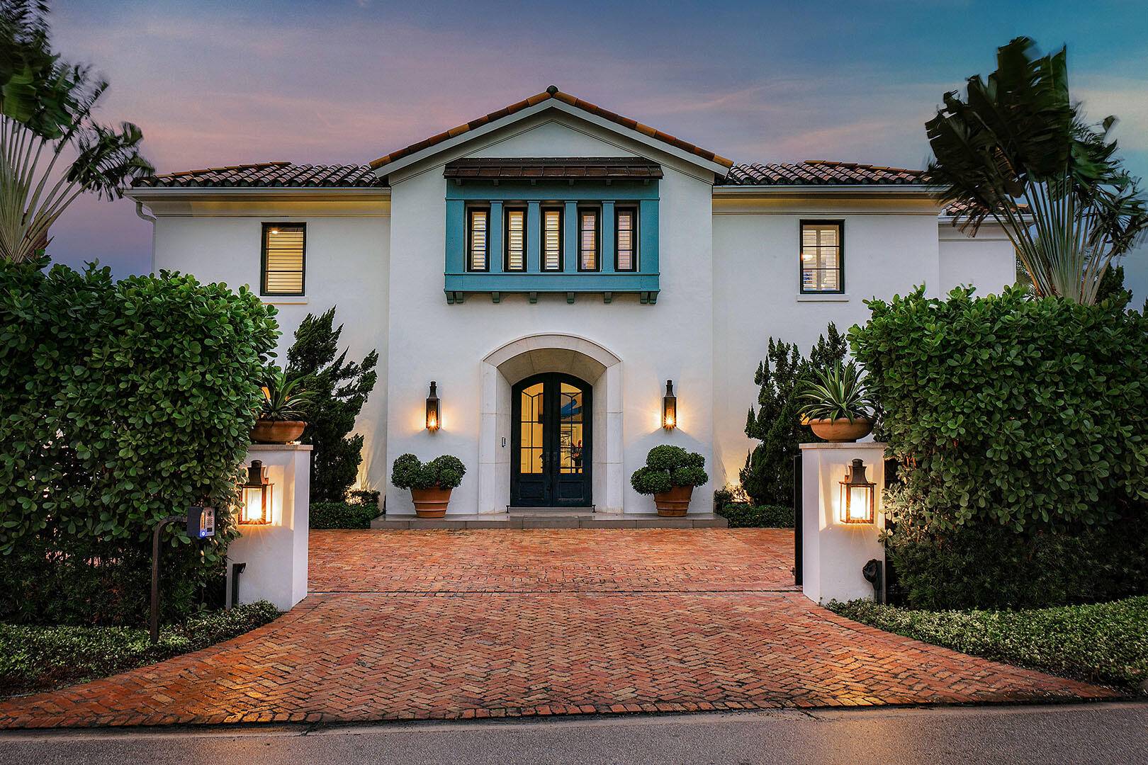 A rare offering on a coveted corner double lot, this Palm Beach inspired estate blends timeless architectural beauty with modern ease across a sprawling, gated setting.