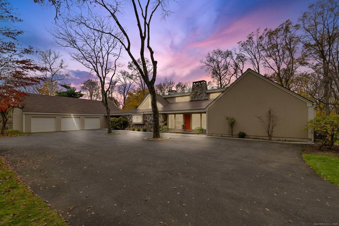 Experience resort style living at 88 Starin Drive, a striking architectural estate set on over 4 acres of privacy in Stamford.