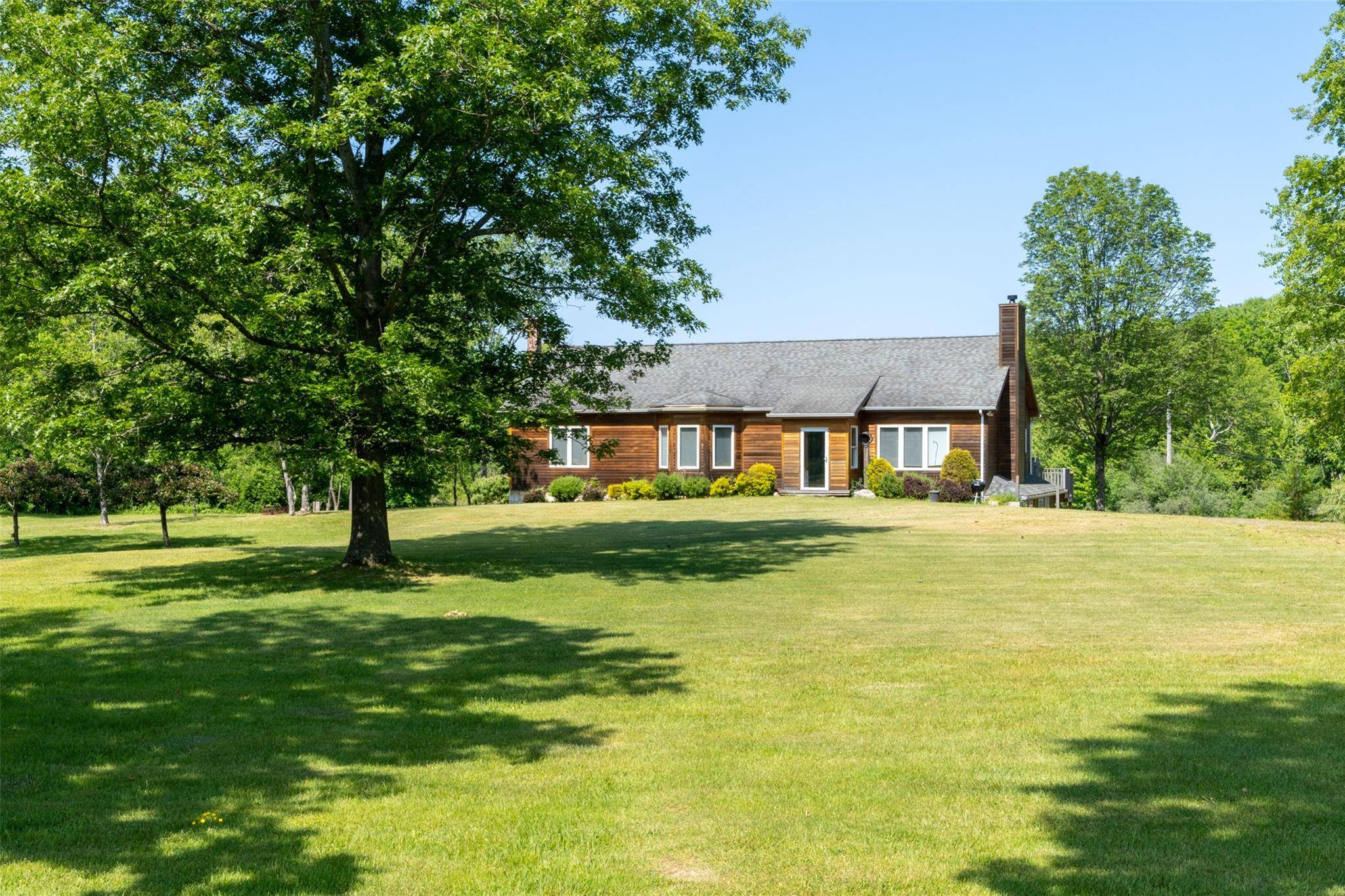 On a country road overlooking a beautiful spring fed pond sits a 3, 228 sq ft cedar sided traditional home.