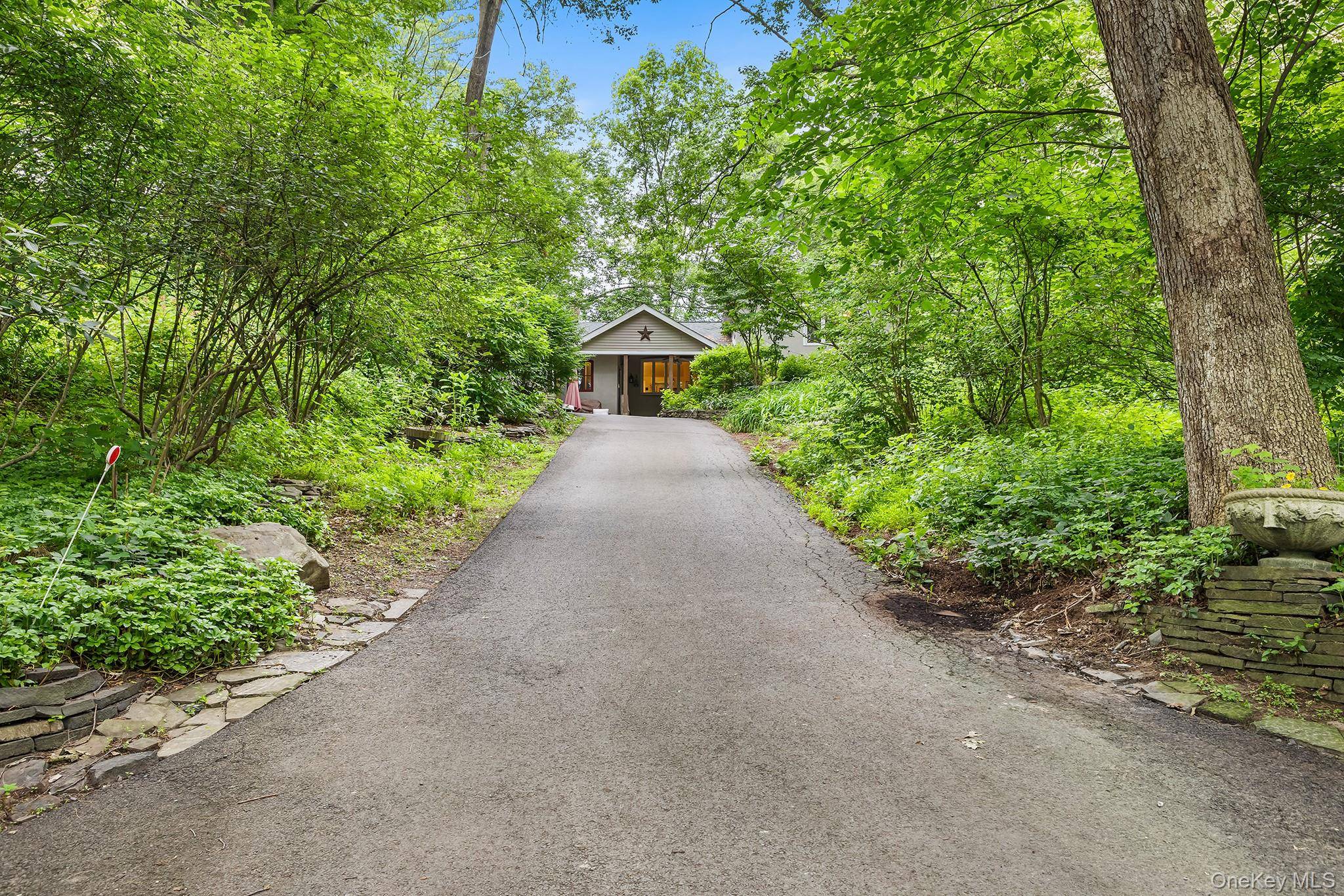 Nestled atop a rock bluff overlooking the Wallkill River, this 4 bedroom, 2.