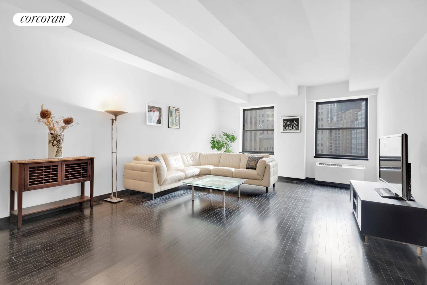 Oversized windows provide unobstructed views of the stunning New York Stock Exchange building in this bright, beautiful and grand one bedroom loft at the coveted 20 Pine Street condominium.