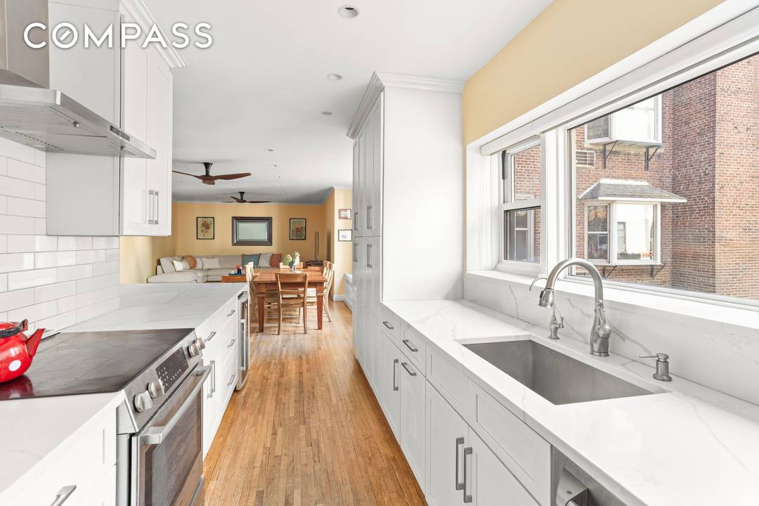 Enter this lovely home and immediately be greeted by beautiful prewar details, including an expansive custom wooden built in bookcase, moldings, oak hardwood flooring, and more.