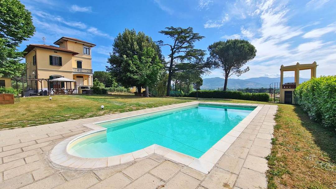Art Nouveau villa with turret, swimming pool, lemon house and garden for sale in a panoramic position in Monte San Savino, Tuscany.