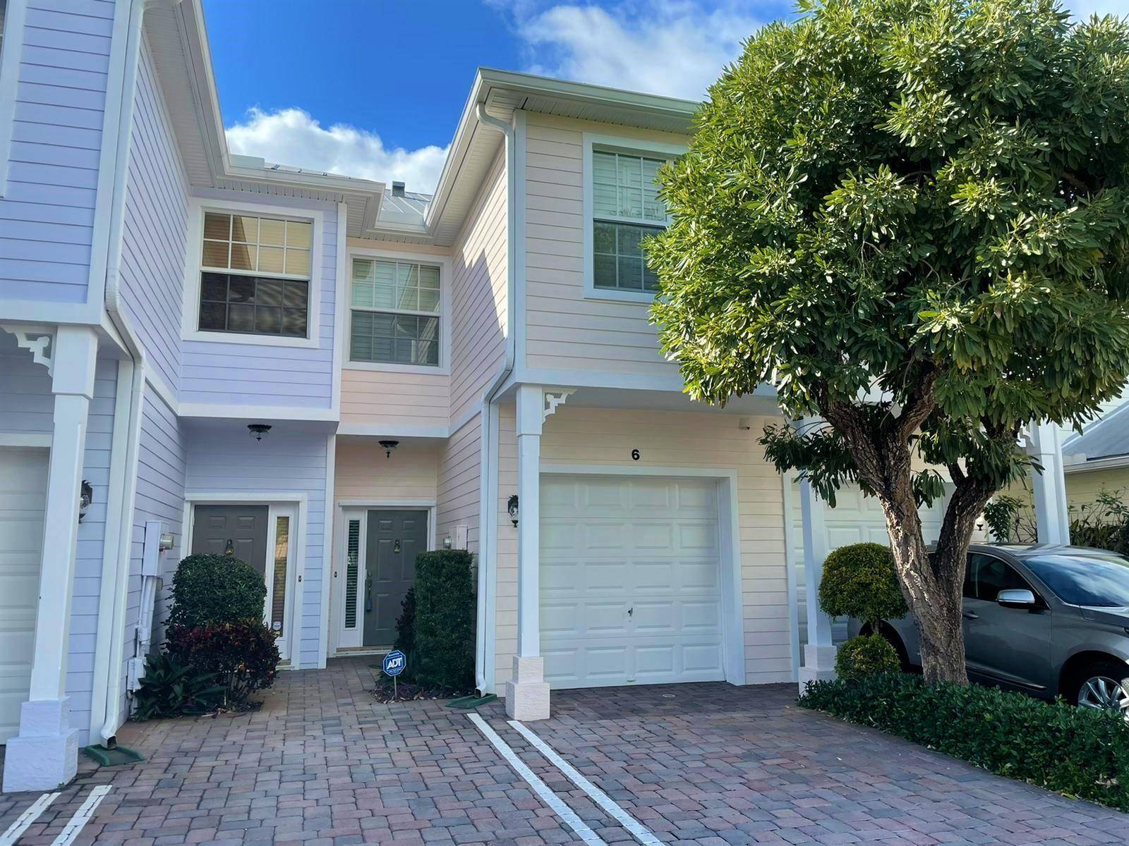 Live close to the beach in this beautiful Key West style townhome in Pineapple Village South.