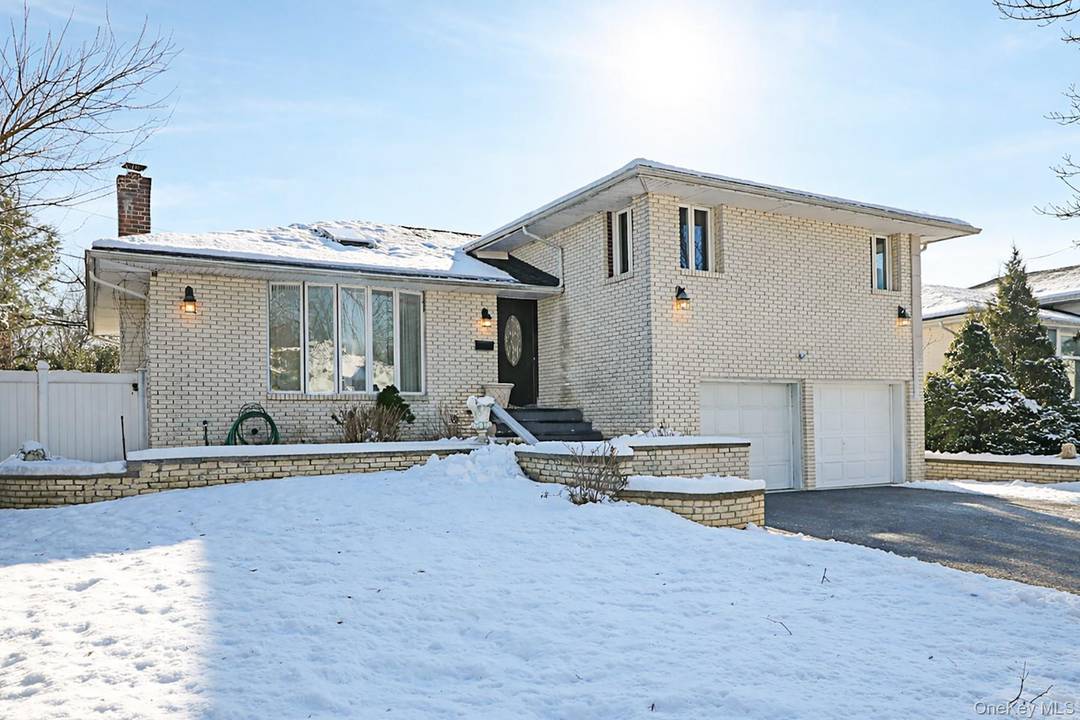 Bright and well maintained four bedroom, three and half bath residence located on a quiet, tree lined street in East Birchwood, Jericho.