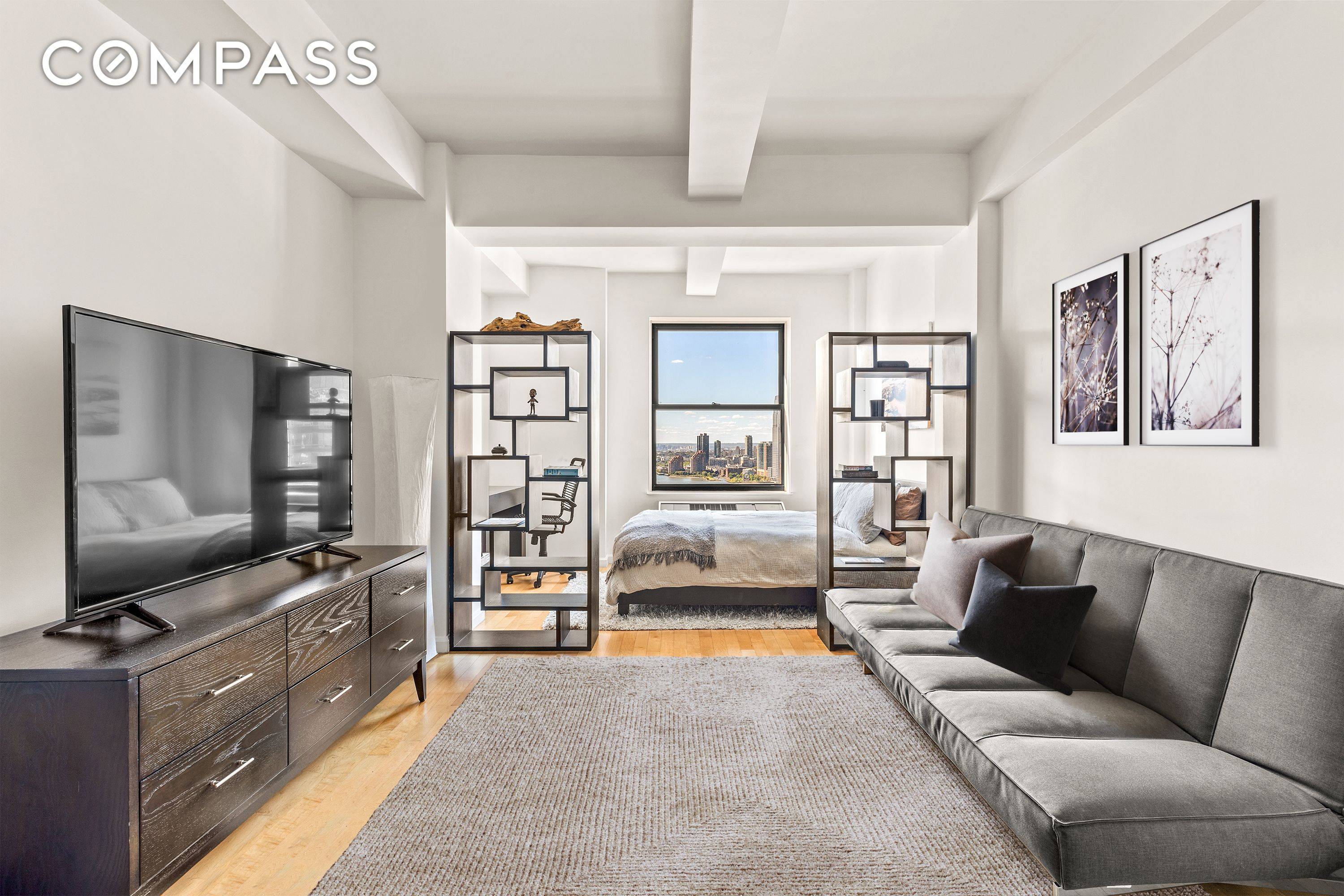 Welcome to Residence 31C, a stunning loft like studio bathed in natural sunlight, offering breathtaking views of the water and city skyline.
