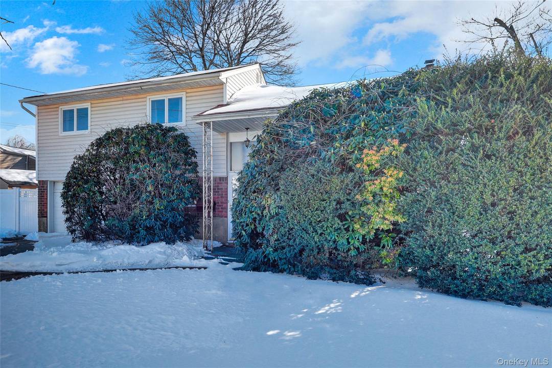 Split level home located in Massapequa, features 3 bedrooms, 1.