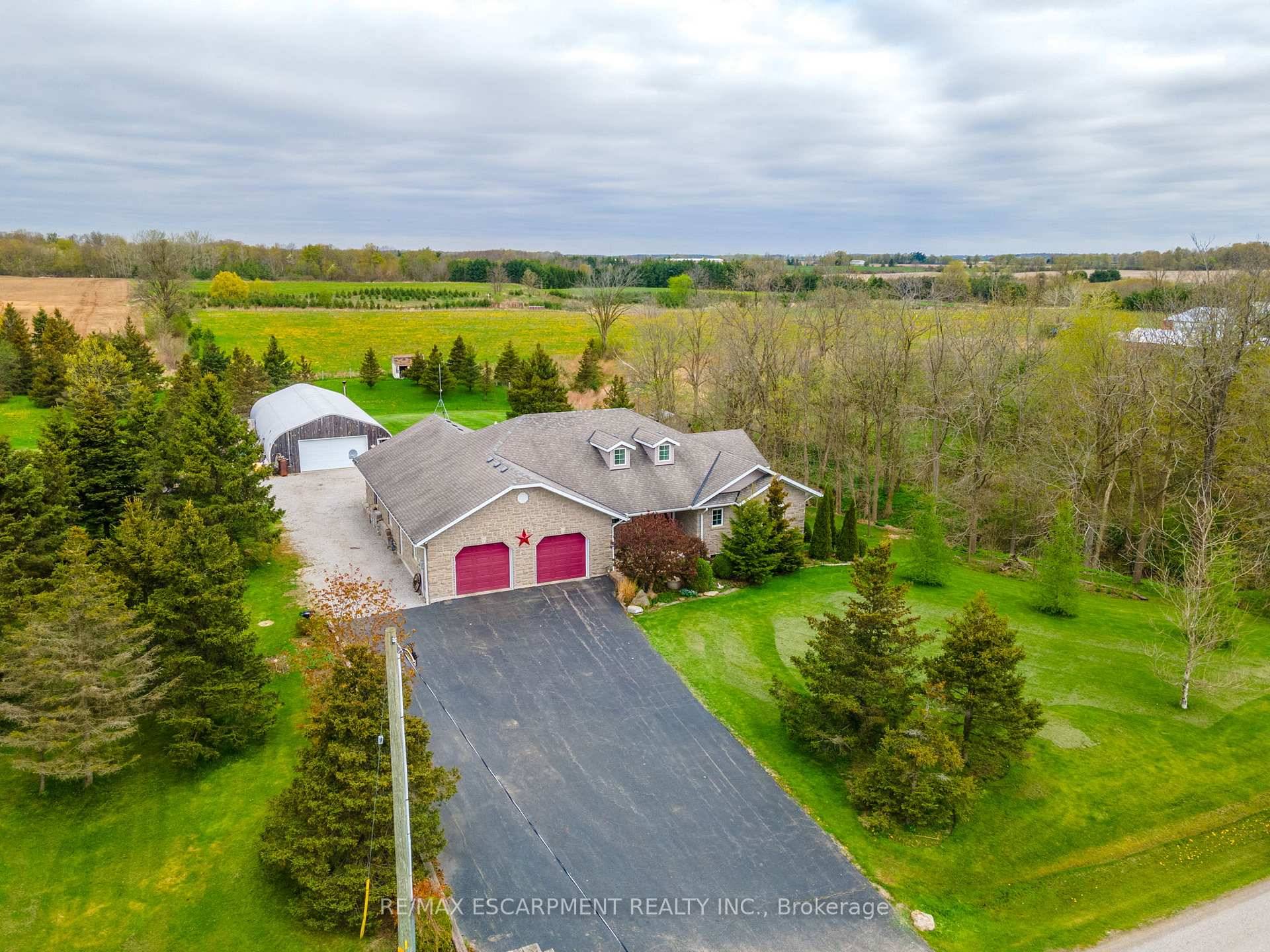 Stunning custom bungalow built in 2005, set on a picturesque 1 acre lot surrounded by open fields, young forest, and a scenic ravine.