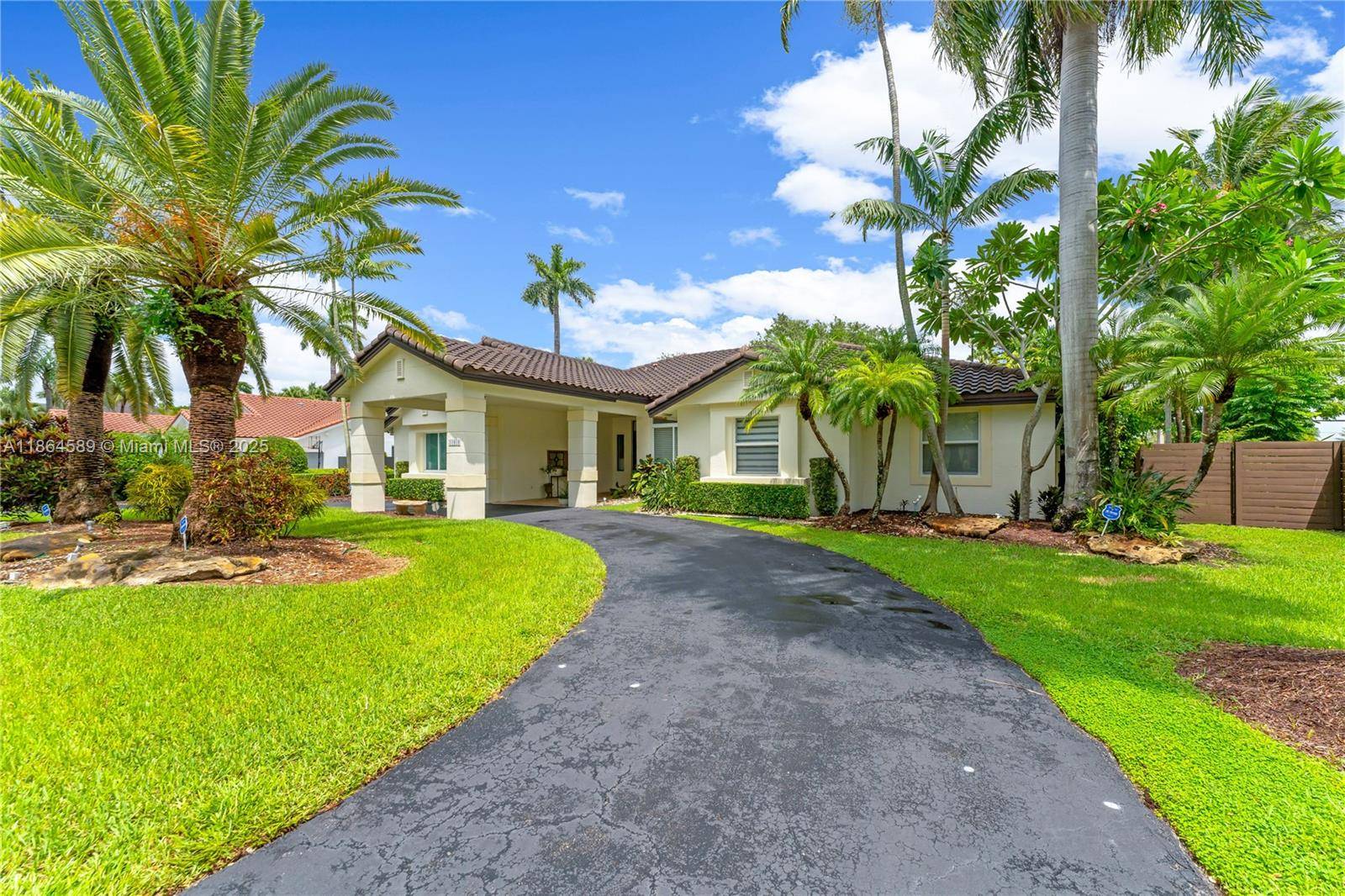 Discover this exceptional property located in the luxurious gated community of Poinciana Gardens.
