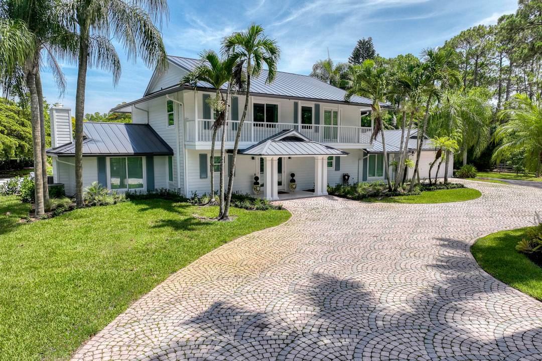 Escape to your private South Florida sanctuary, a modern French Country estate that redefines refined living on over five acres of lush, equestrian land.