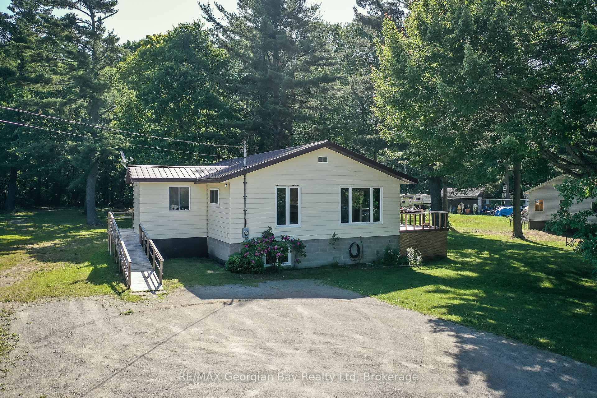 Value packed opportunity on this spacious 1400ft2 raised bungalow with a full basement situated on a 1 acre lot across from Georgian Bay.