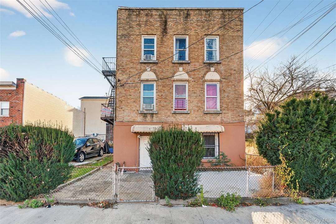 Fully detached brick 3 family on a 55 x 100 double lot offering major development potential, including the possibility of constructing an additional 2 family home on the left side ...