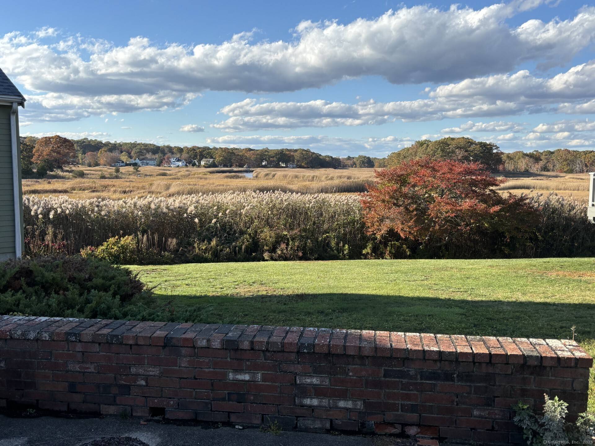 Large ranch unit with views of the Hammonassett River from several rooms and the brick walled patio.