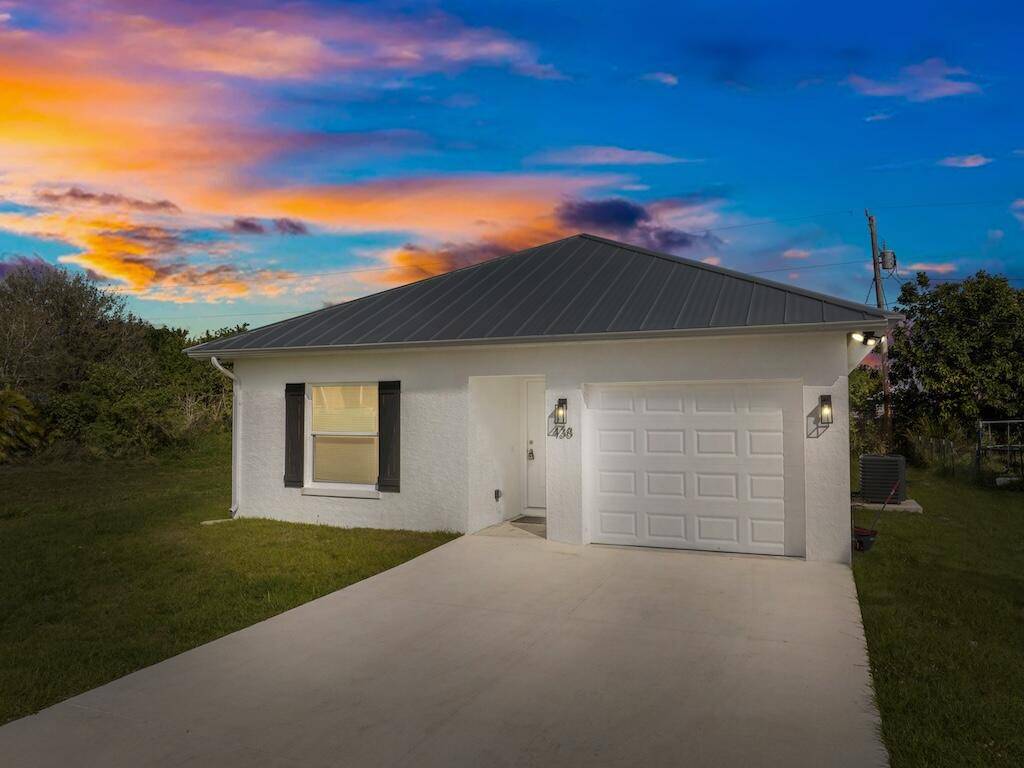 Why wait or build ? Modern 3 bed, 2 bath concrete block home in Vero Beach features a metal roof, high impact glass, stainless steel appliances, and granite countertops.