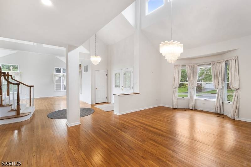 A Rare Gem with a First Floor Primary Suite and Wooded Views !