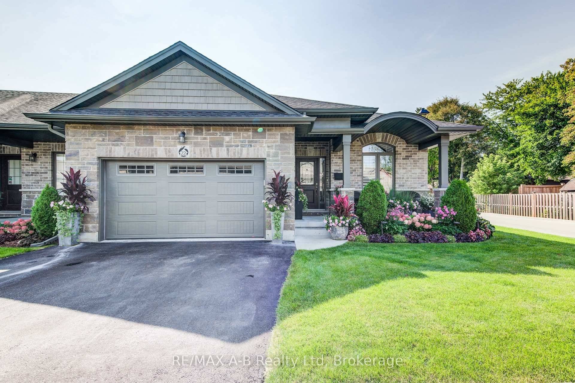Welcome to this beautifully upgraded end unit bungalow townhouse featuring a striking barrel roofline, a covered front oversized porch and a warm foyer that welcomes you home.