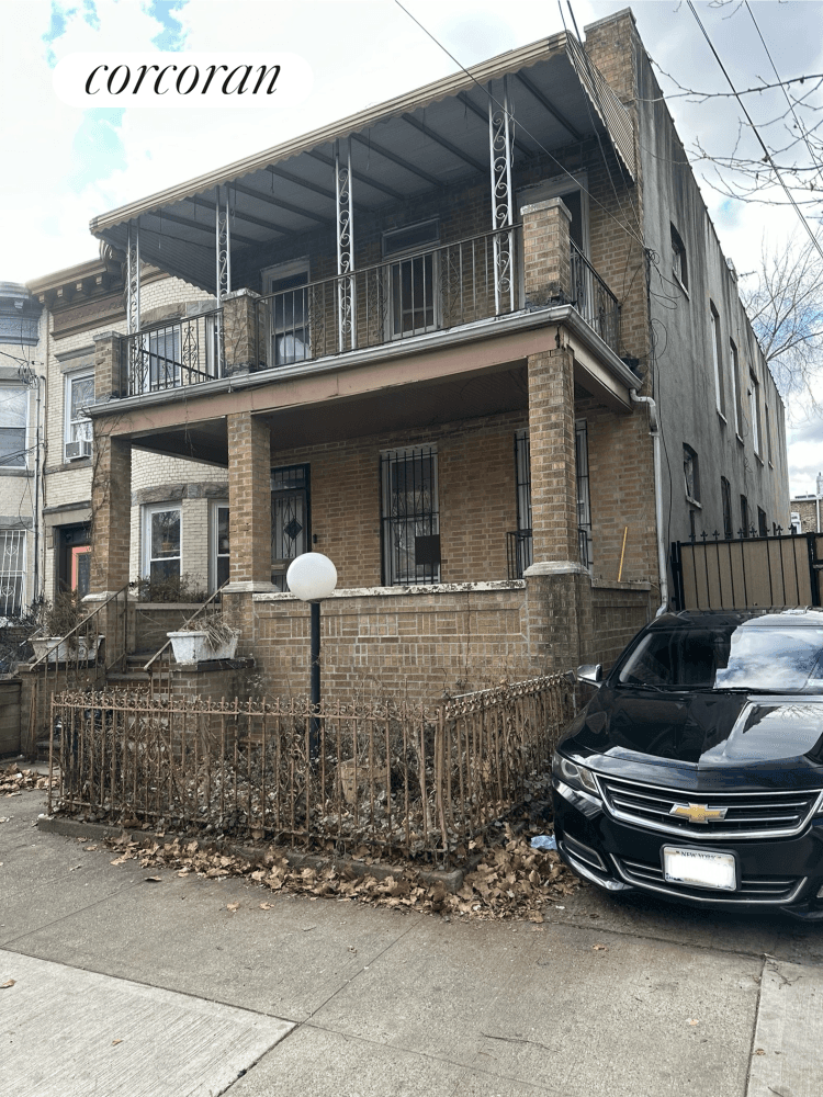 Flatbush semi attached two family brick home with shared driveway.