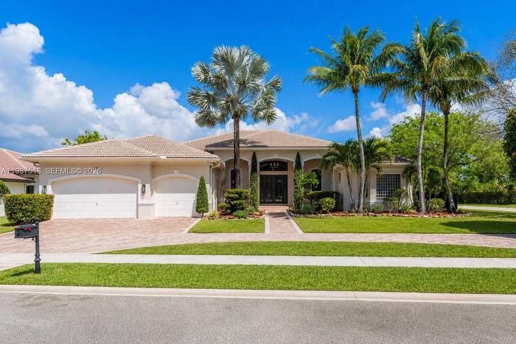 Stunning lakefront home located in the exclusive guard gated community of Riverstone in West Davie.