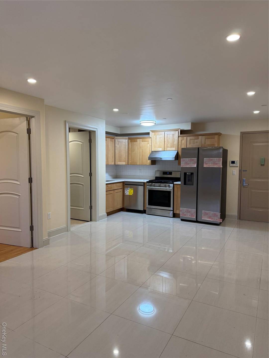 Bright and inviting two bedroom, ground level apartment featuring an open concept layout that seamlessly connects the kitchen and living room.