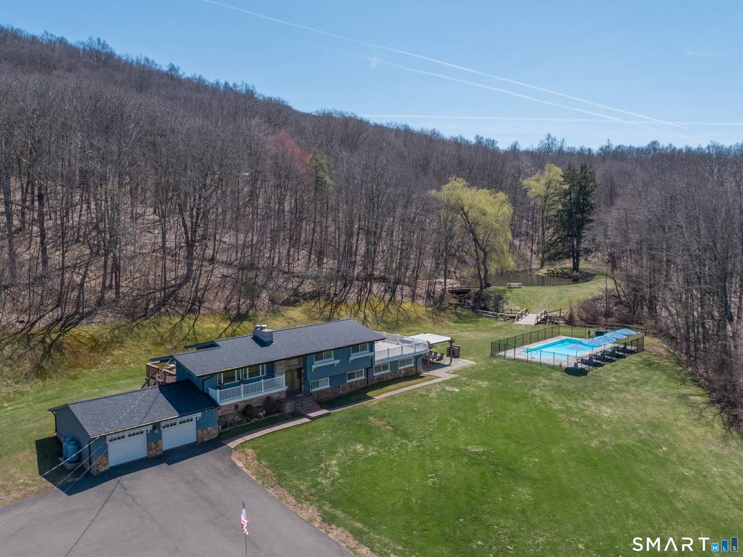 Set on over 20 breathtaking, wooded acres, this property offers a rare blend of privacy, natural beauty, and flexible living.