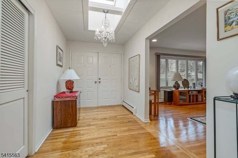 This true ranch offers a calm, easy rhythm of living on a private, wooded 0.