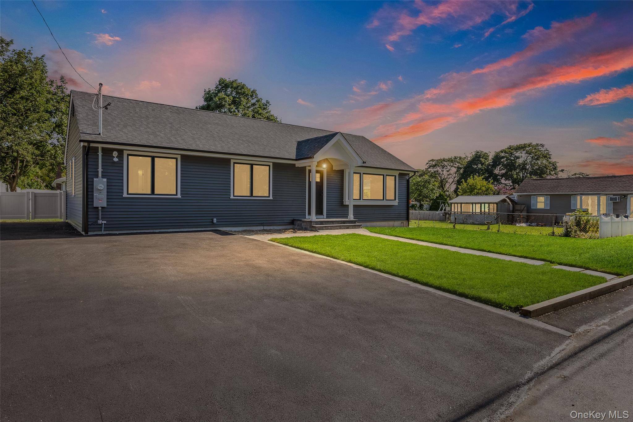 Welcome to 28 E 6th Street, an exquisitely renovated ranch style residence nestled in the heart of award winning Patchogue Village.