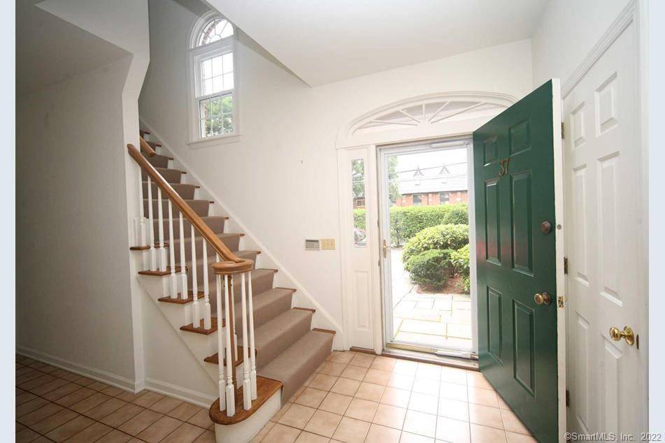 Welcome to this stately, sun filled brick townhome, built by renowned builder the late Archie Stewart, celebrated for quality construction, generous room sizes, and exceptional storage.