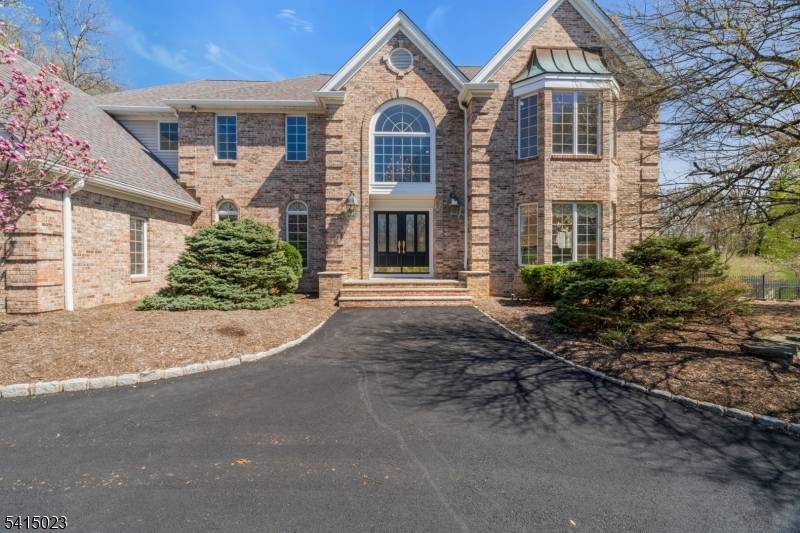 Welcome to this impressive custom designed brick colonial set on a quiet cul de sac, offering refined living, exceptional space, and timeless appeal.