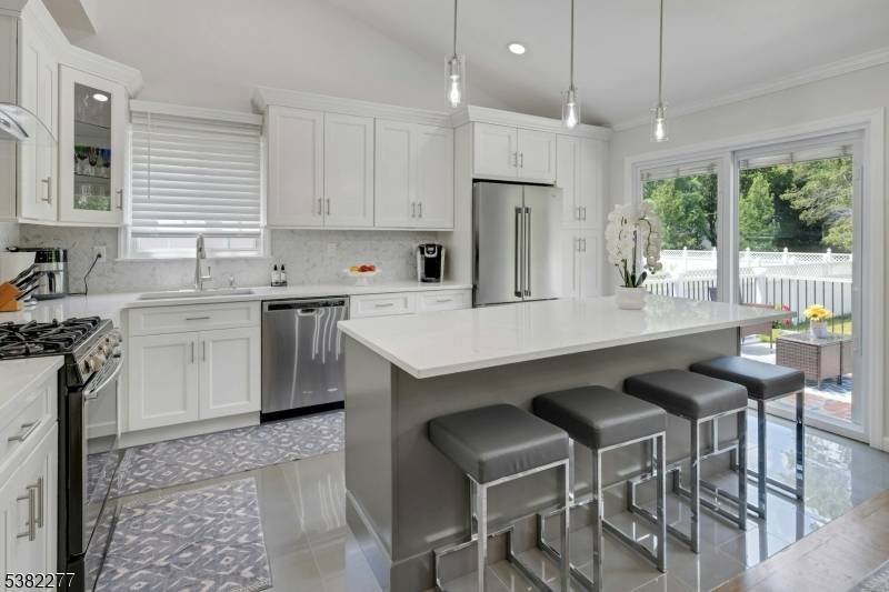 Beautifully updated 4 level split featuring a stunning new kitchen with vaulted ceilings, quartz countertops, and stainless steel appliances refrigerator not included.